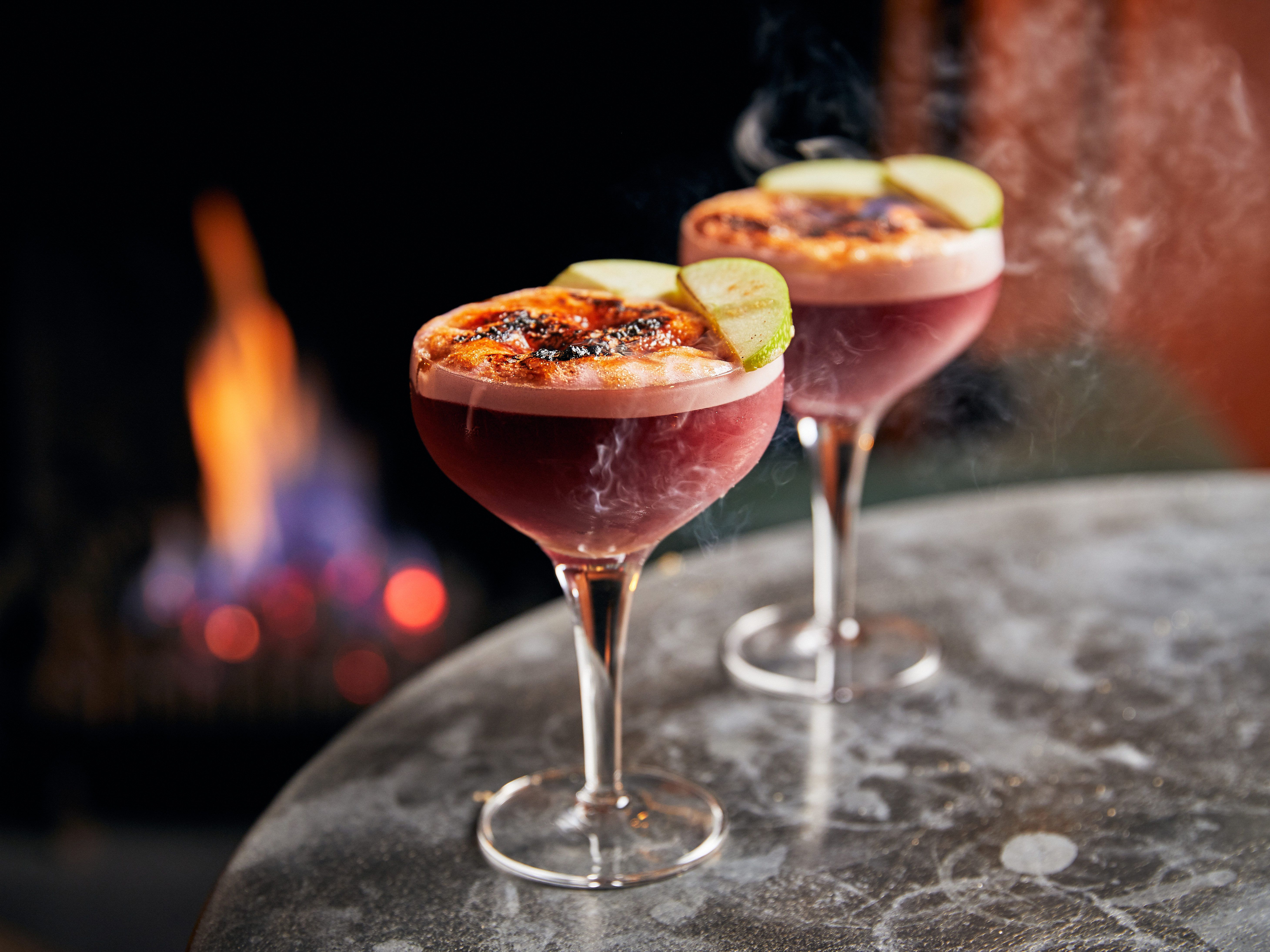 Cocktails in front of a fireplace