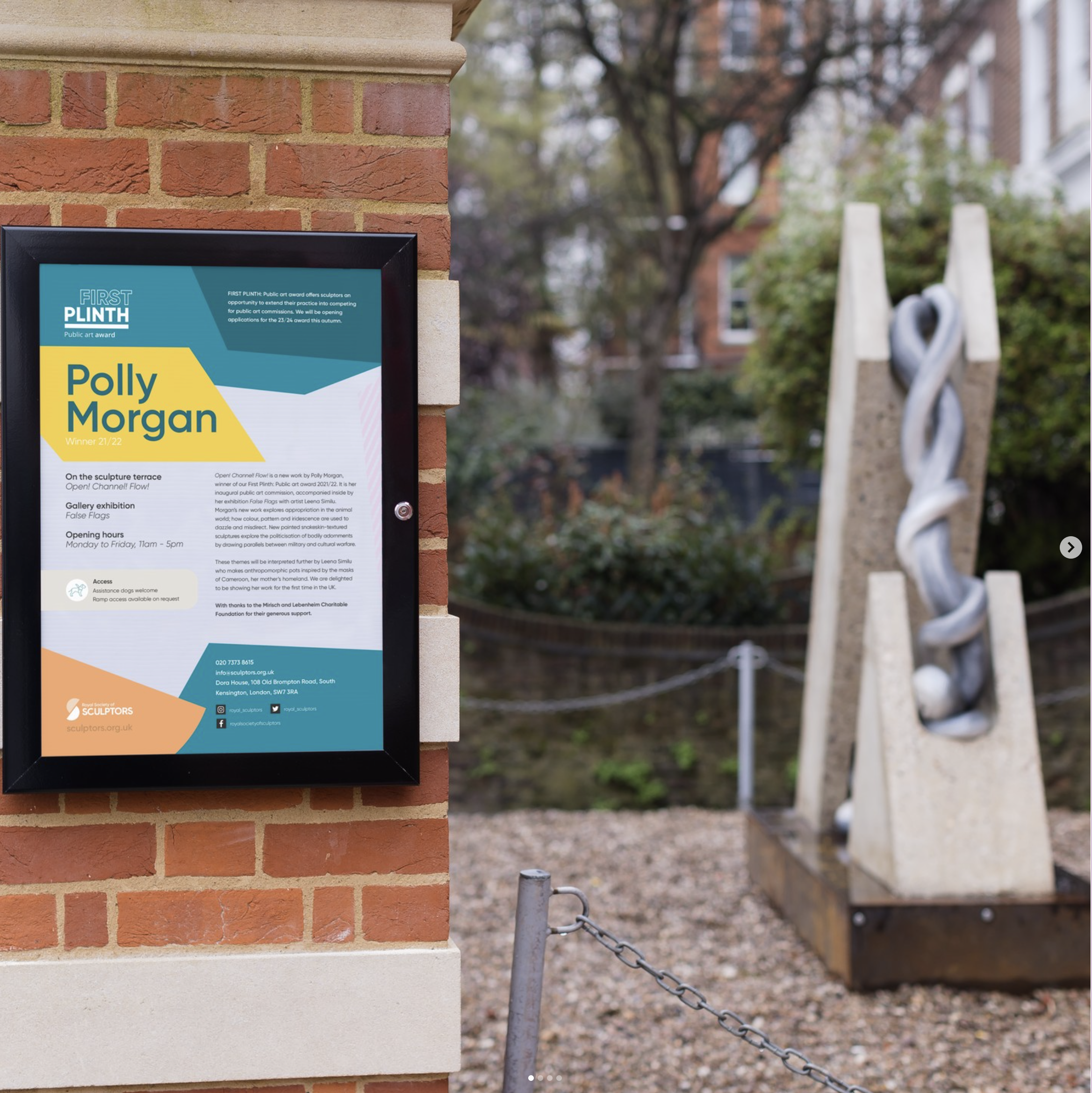 View of poster and sculpture from outside of the exhibition